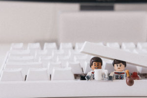 Two Lego men in a keyboard work from home during the coronavirus pandemic.